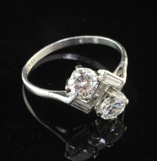 A 1930s Art Deco platinum and diamond crossover ring, size N.